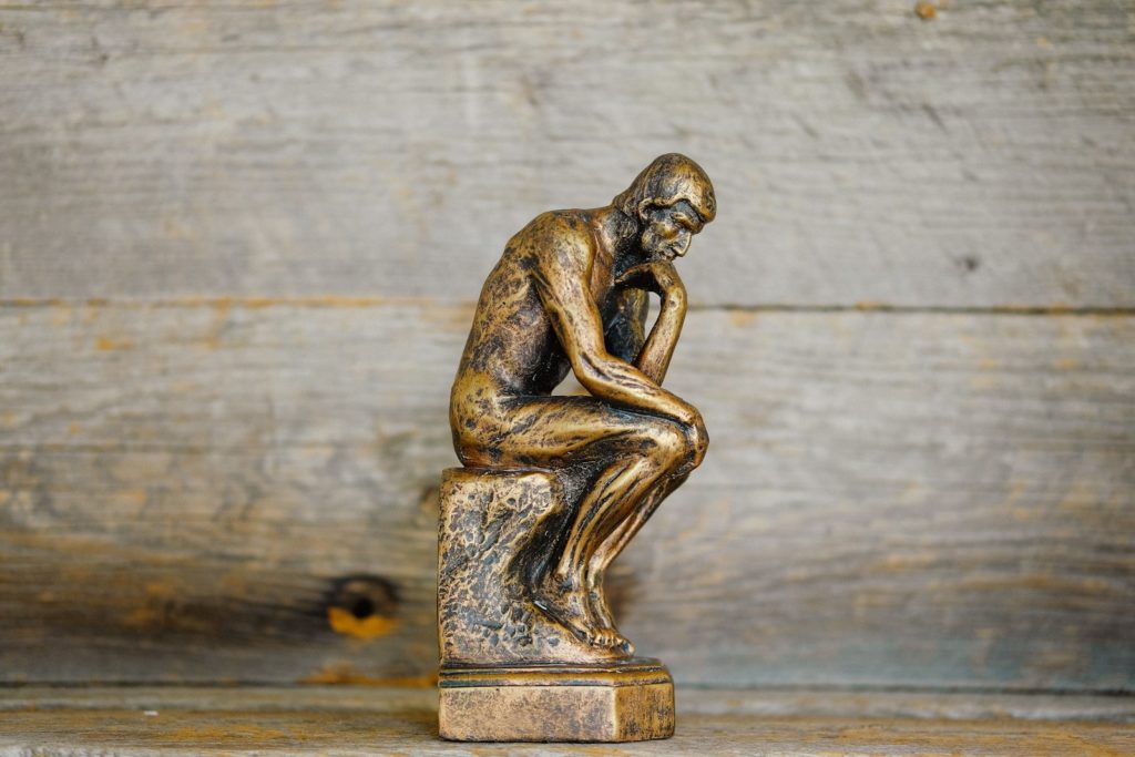 green ceramic statue of a man
